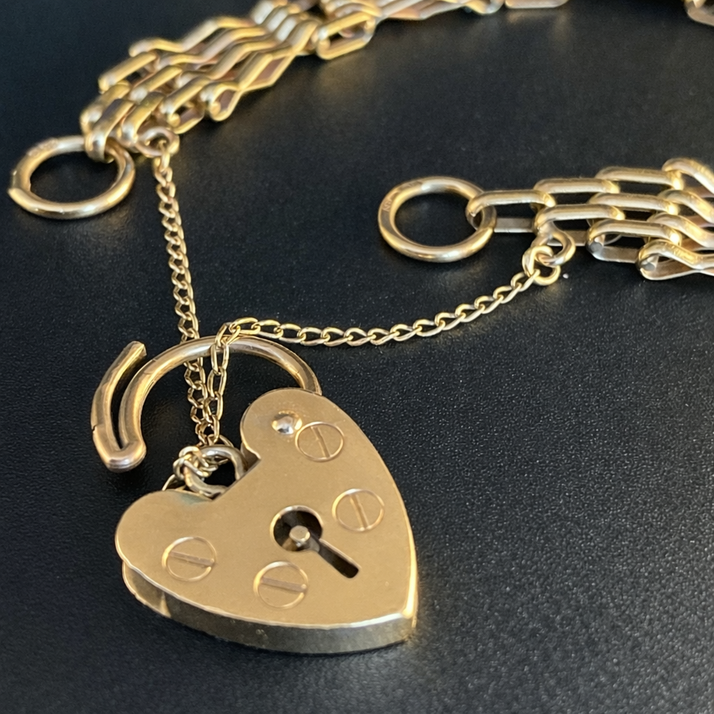 A 9ct gold heart padlock bracelet.